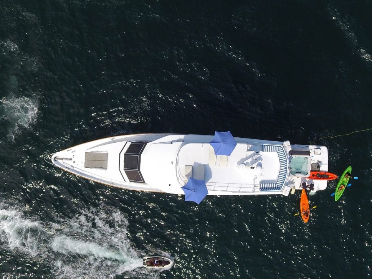 a man riding on the back of a boat in the water