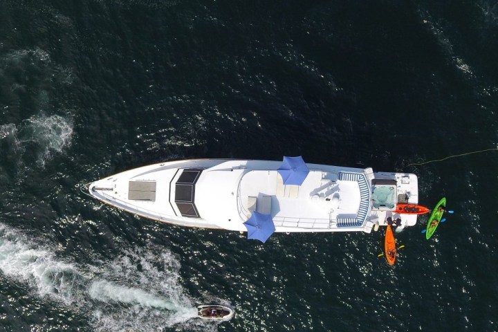 a man riding on the back of a boat in the water