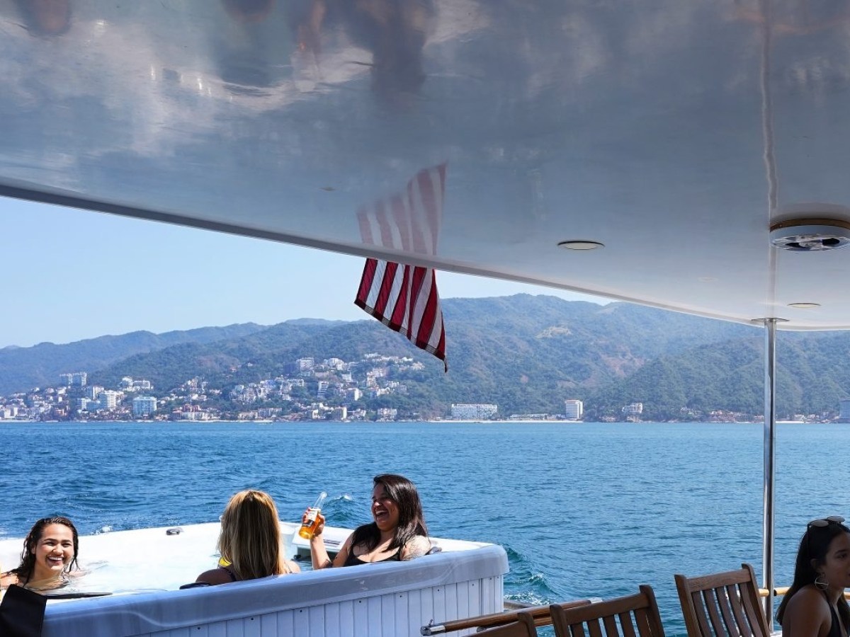 a group of people sitting in a boat on a body of water
