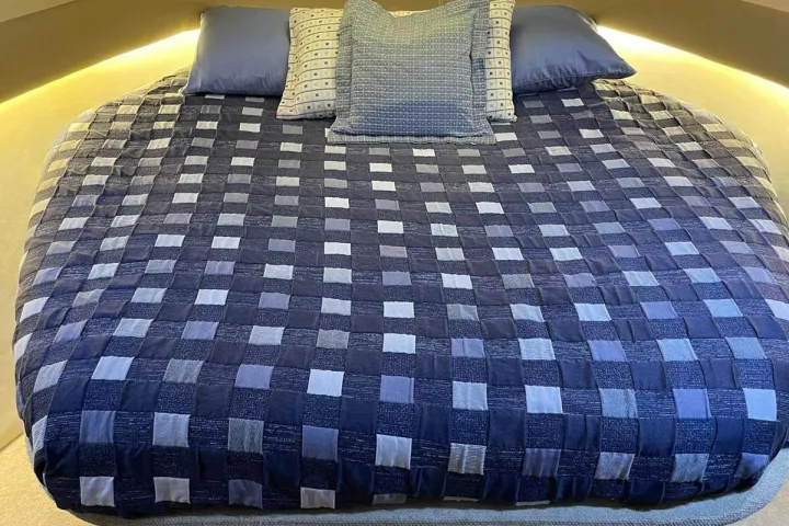 a bedroom with a bed and desk in a room