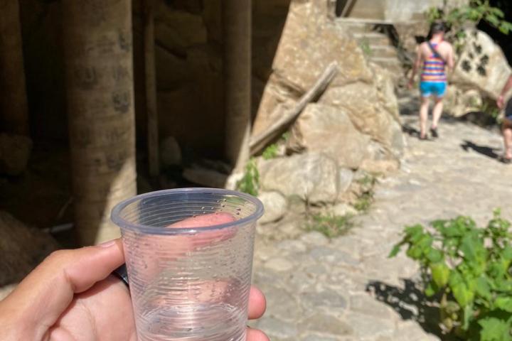 a hand holding a glass of beer