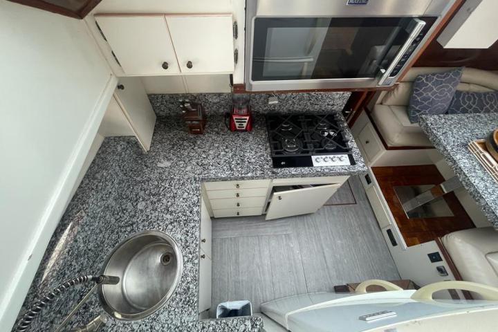 a stove top oven sitting next to a sink