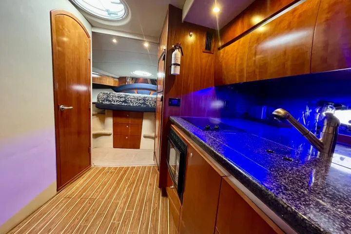a large kitchen with stainless steel appliances and wooden cabinets
