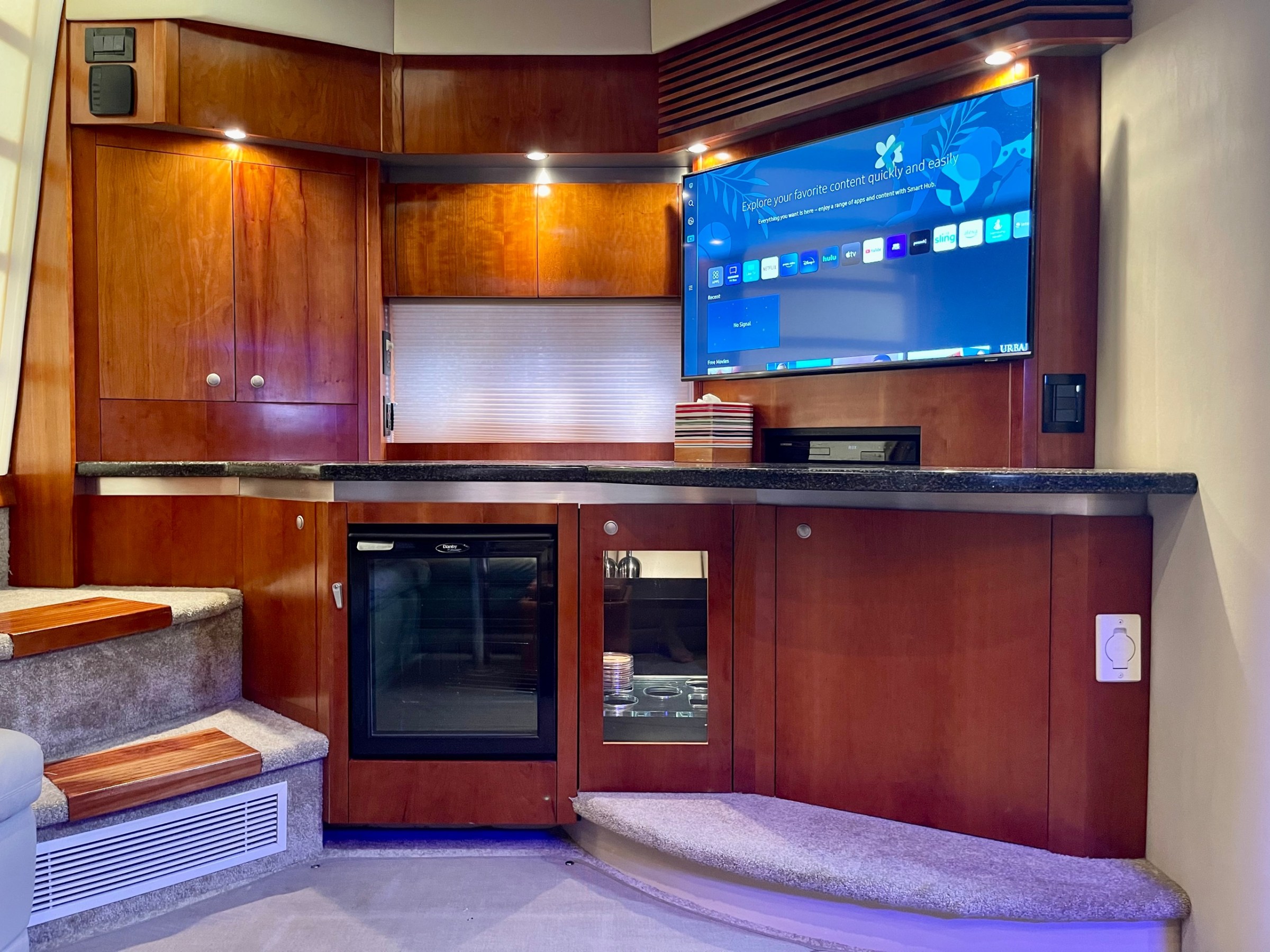 a kitchen with wooden cabinets and a microwave