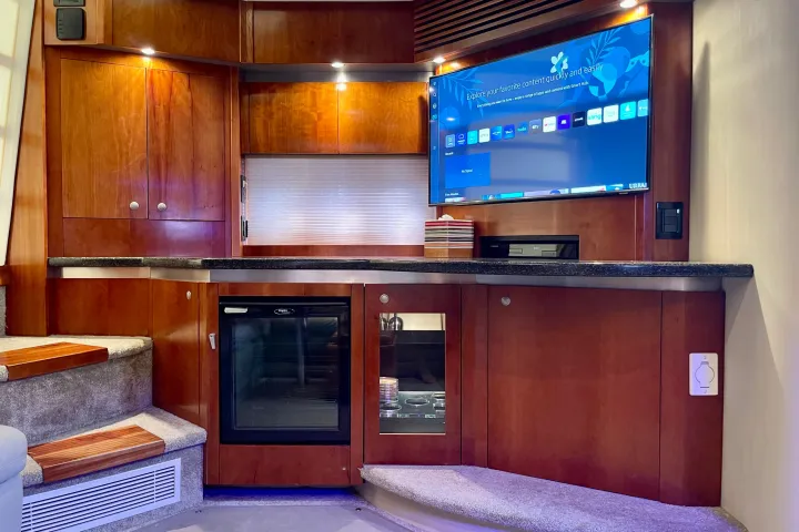 a kitchen with wooden cabinets and a microwave