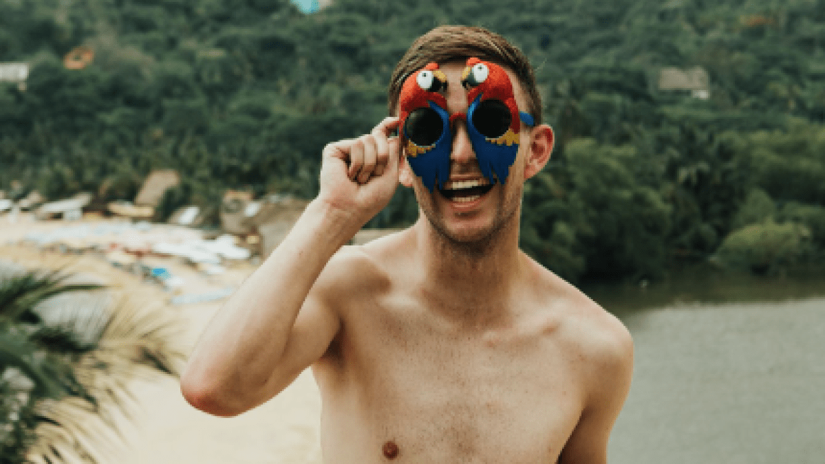 a man standing next to a body of water