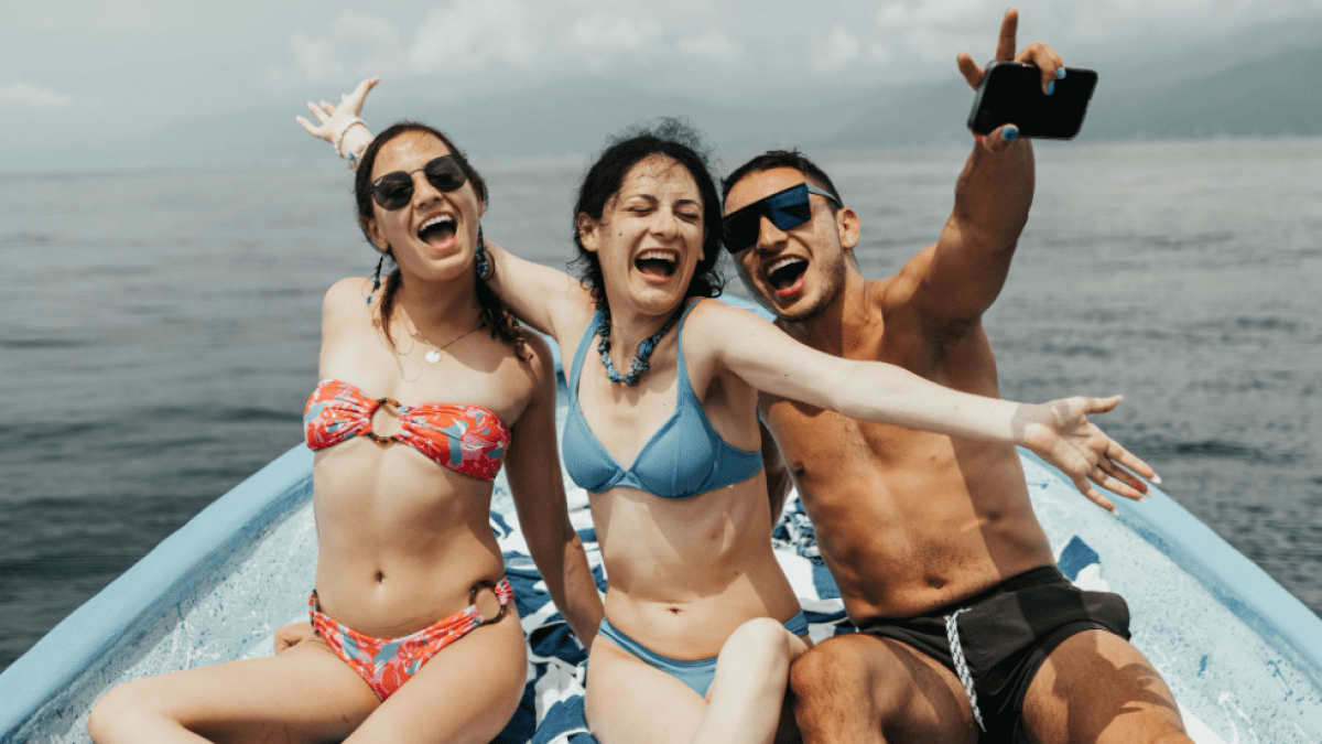 a group of people standing next to a body of water