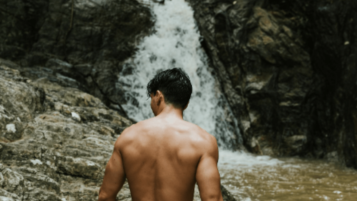 a man standing next to a river