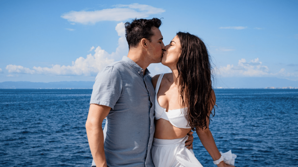 a person standing next to a body of water