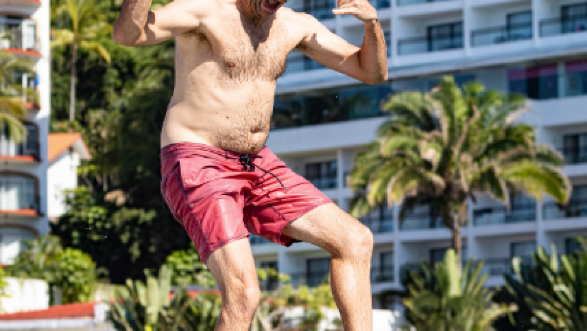 a man jumping in the air to catch a frisbee