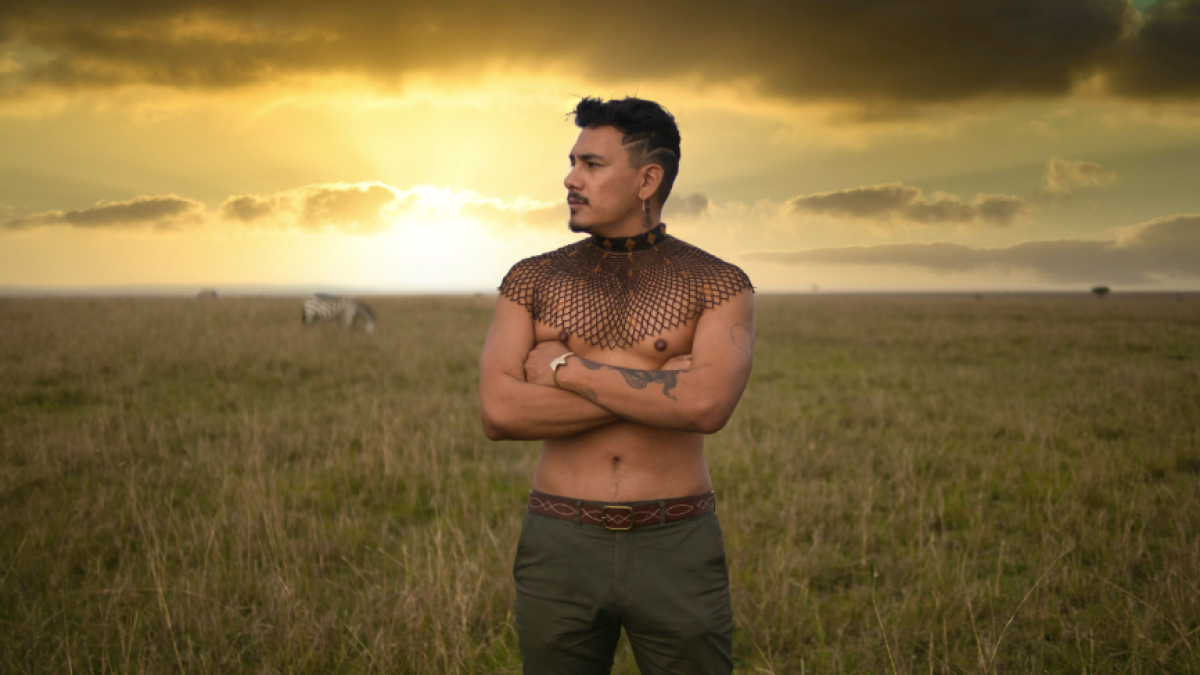 a man standing on top of a grass covered field