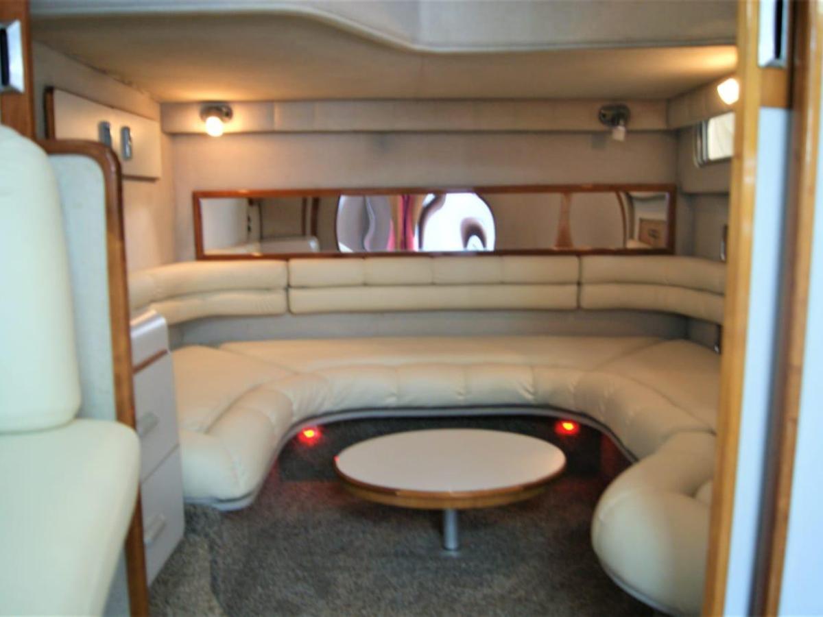 a living area with a sink and a chair in a room