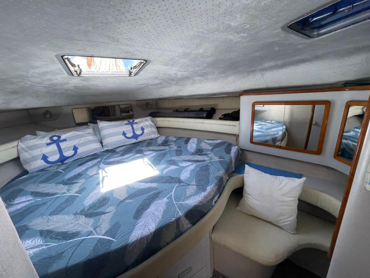 a bedroom with a bed next to a car
