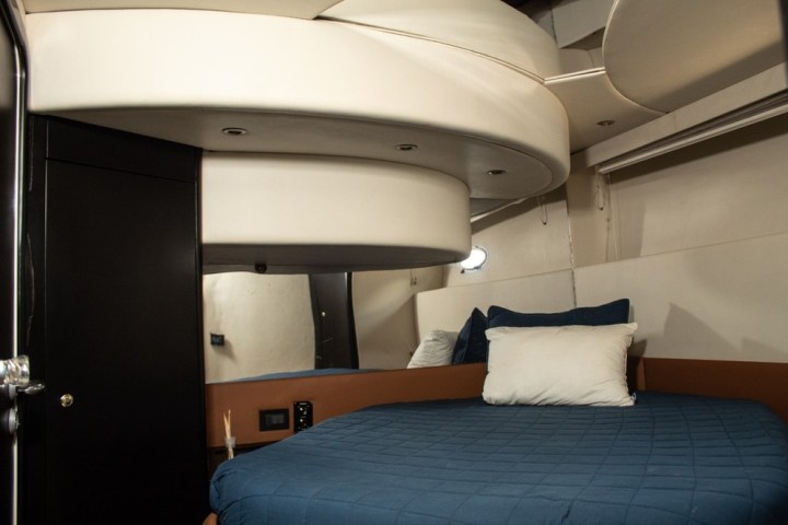 a bedroom with a bed and desk in a room