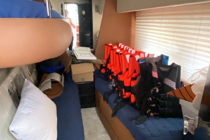 a bedroom with a bed and desk in a room