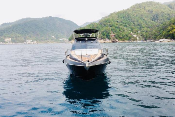 a small boat in a body of water with a mountain in the background
