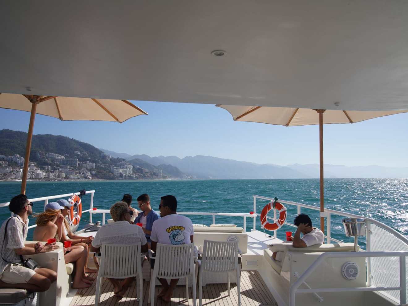 a group of people sitting at a beach