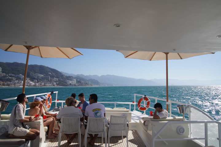 a group of people sitting at a beach