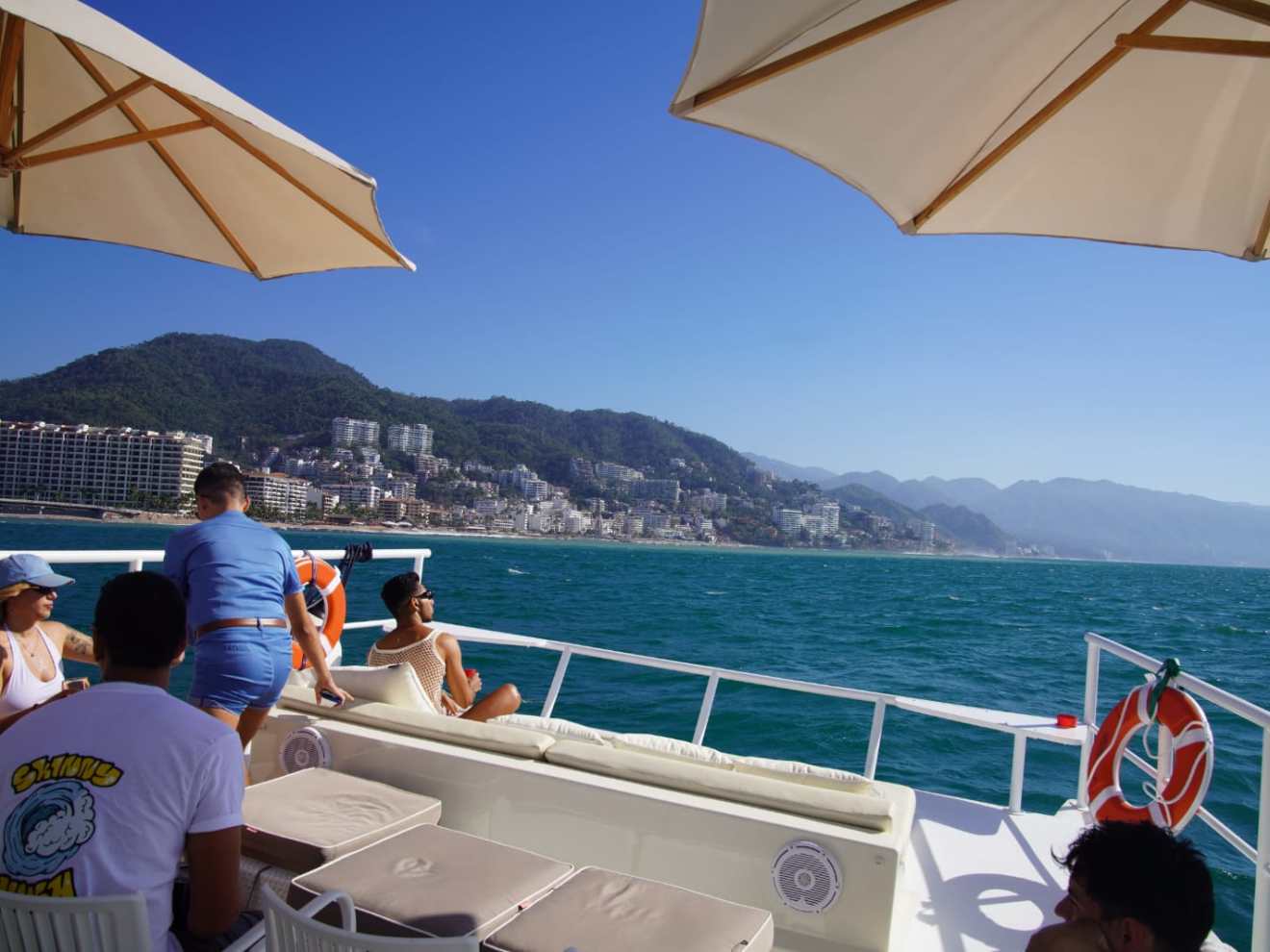 a group of people sitting at a table with an umbrella