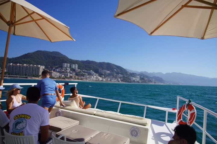 a group of people sitting at a table with an umbrella