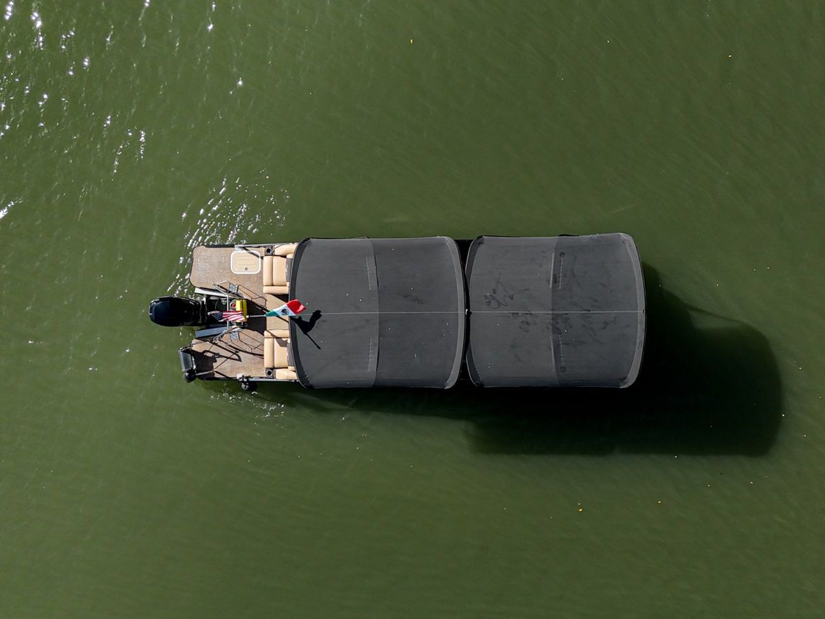 a green boat on a body of water
