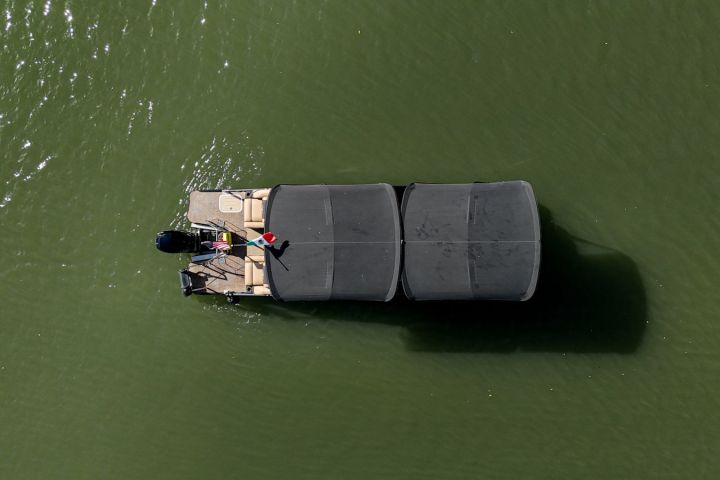 a green boat on a body of water