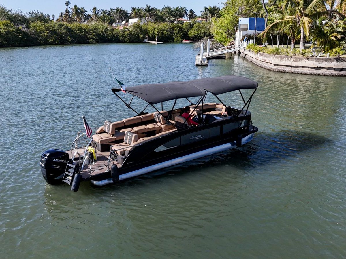a boat floating along a river next to a body of water