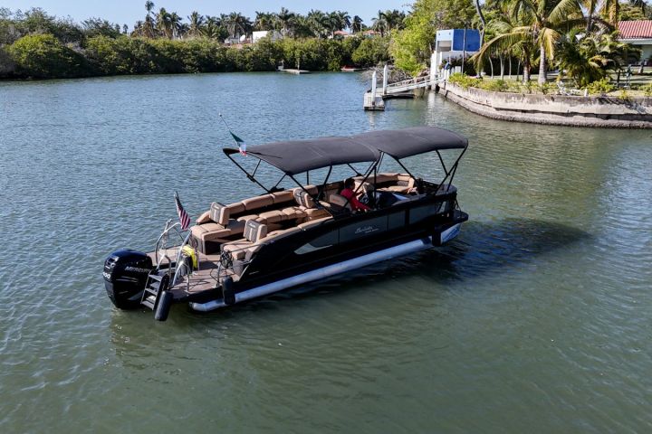 a boat floating along a river next to a body of water
