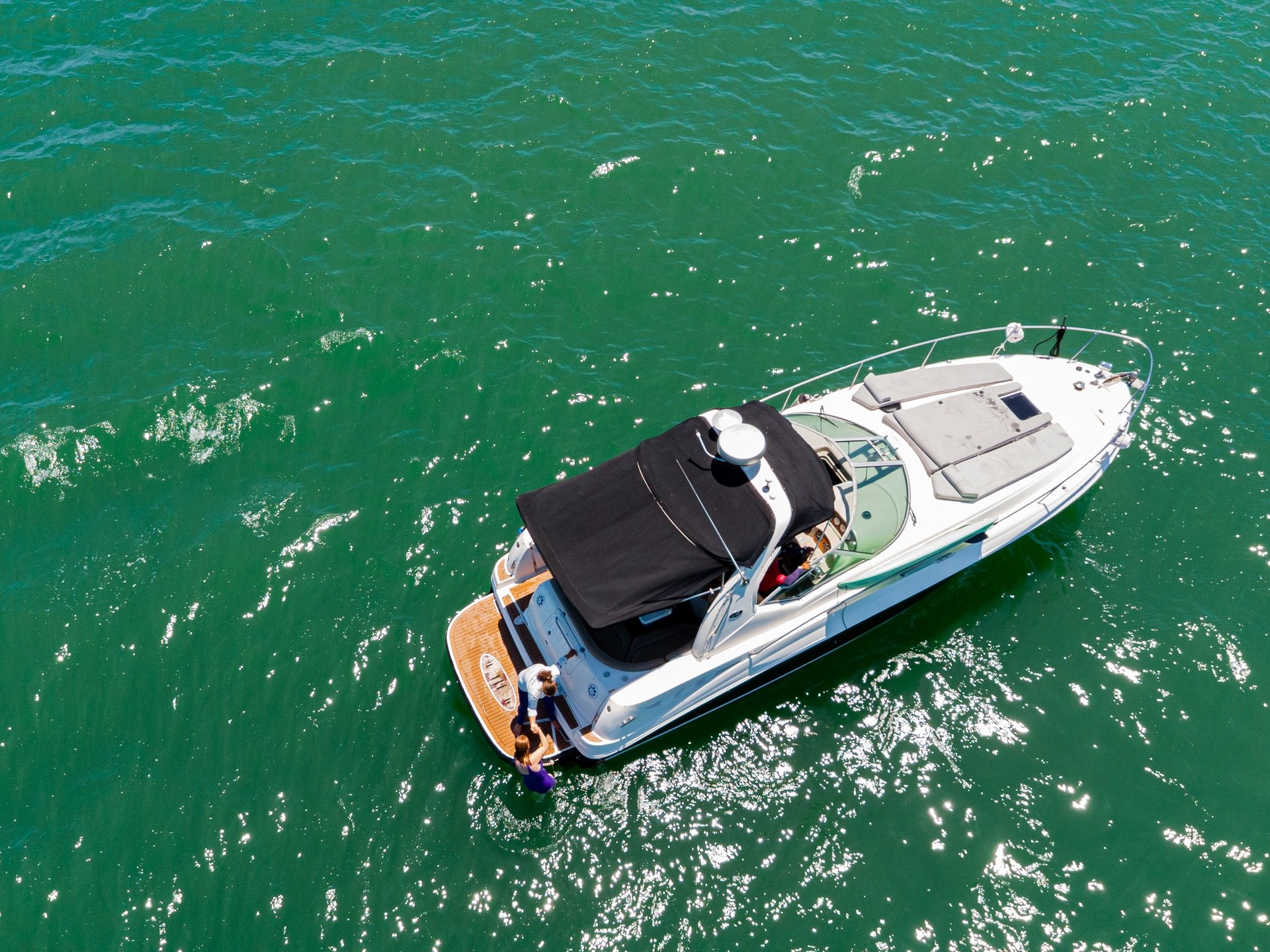 a green boat on a body of water