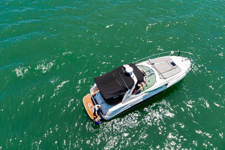 a green boat on a body of water