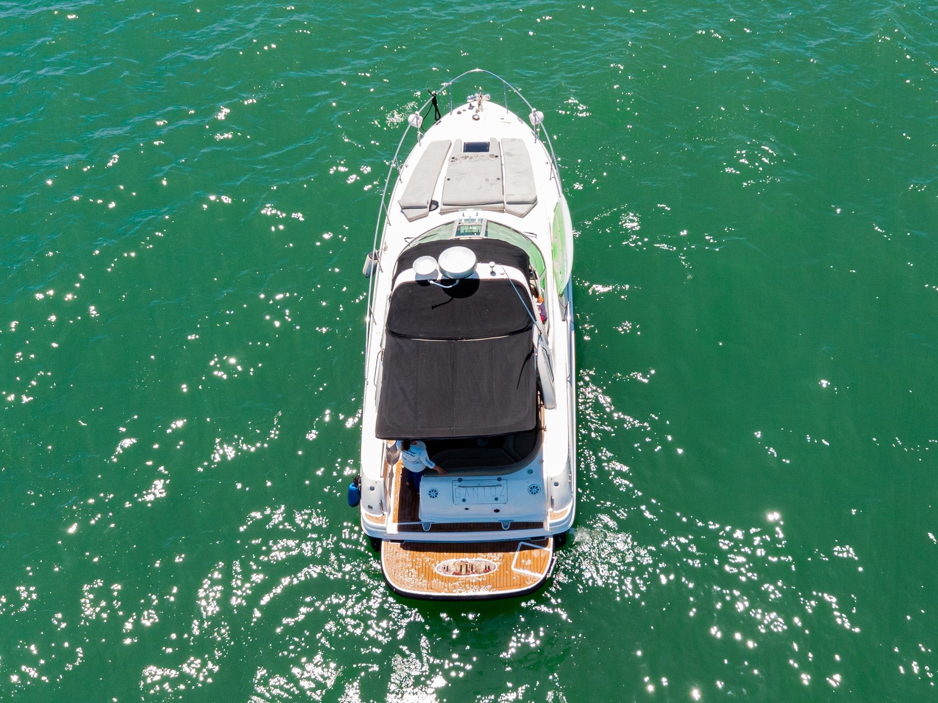a green boat on a body of water