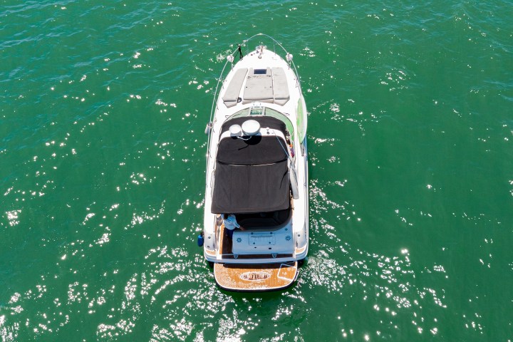 a green boat on a body of water
