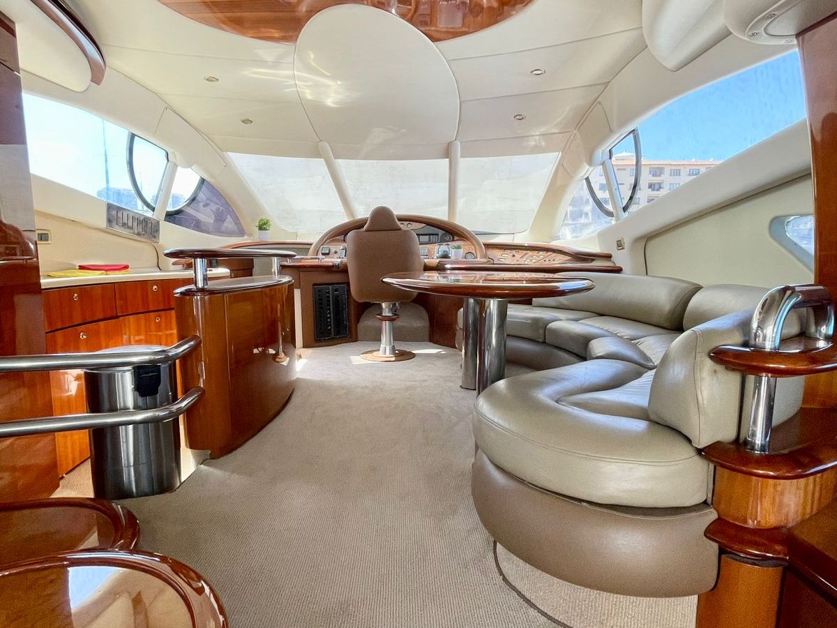 Luxurious yacht interior with wooden accents and beige seating.