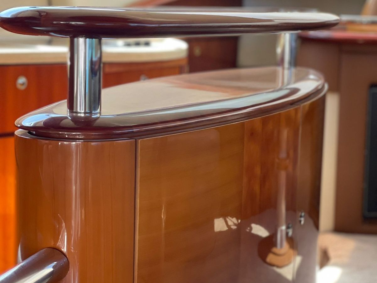 Luxury yacht interior with polished wooden surfaces and modern fixtures.